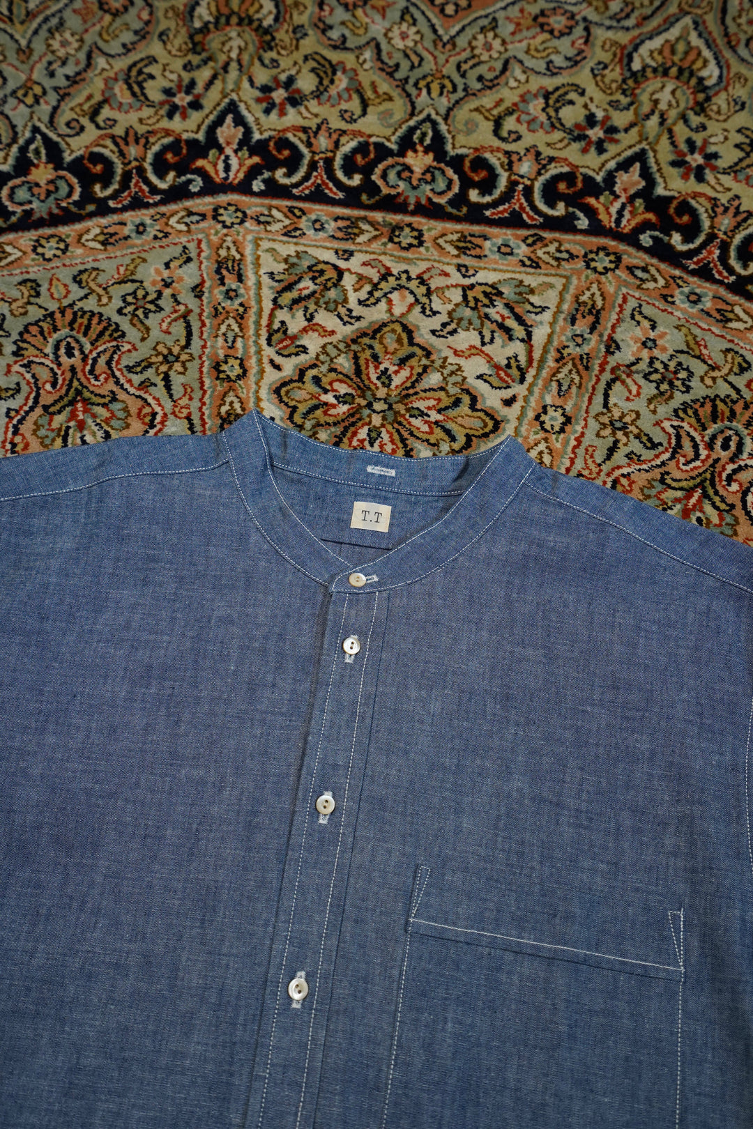 Taiga Takahashi(タイガタカハシ)のBAND COLLAR SHIRT(INDIGO CHAMBRAY